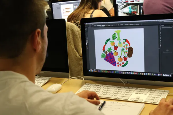 A student creating artwork on a computer