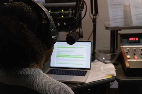 A student talking into a microphone