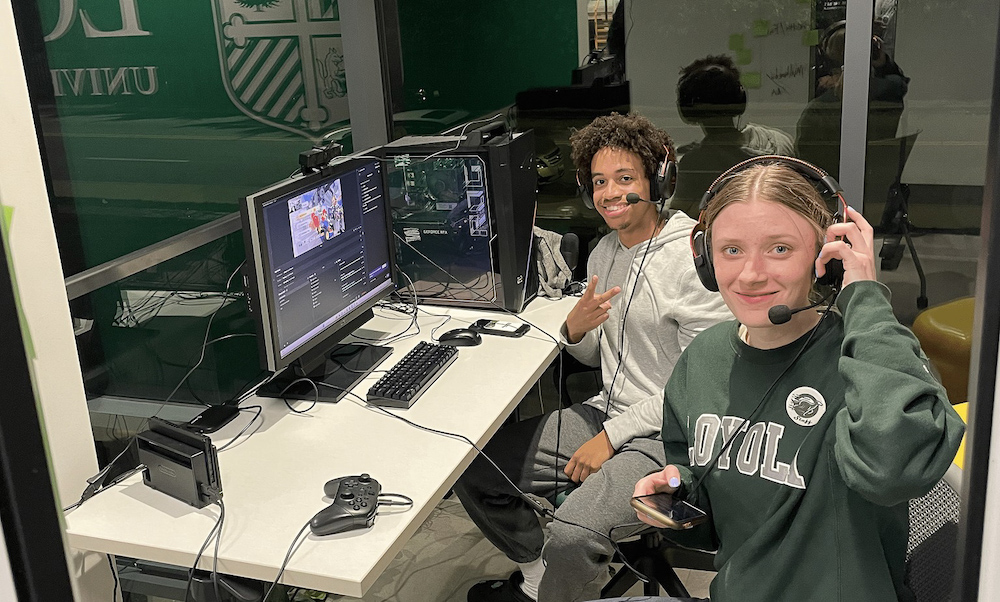 Two students sitting at a computer during HoundHacks hack-a-thon