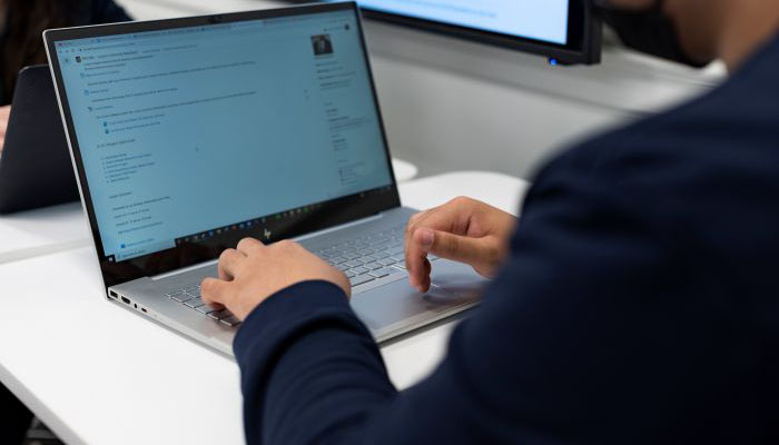 Person typing on a laptop.