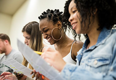 4 students reading papers