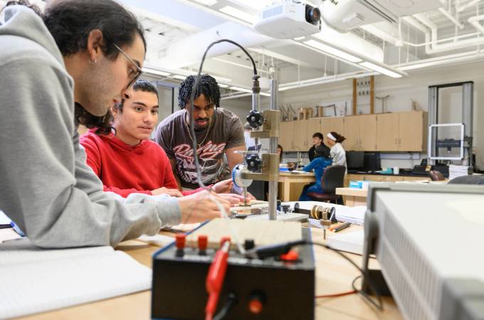 Electrical engineering students working in a lab setting