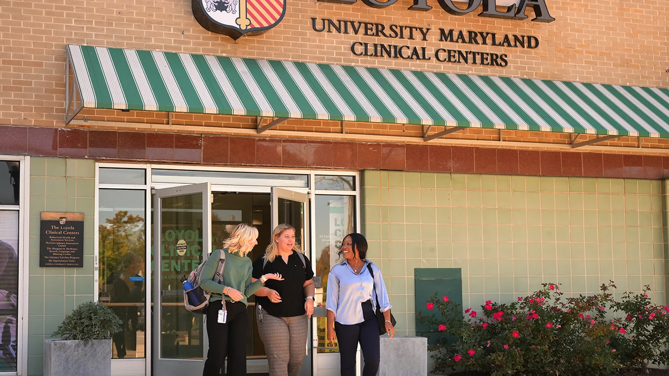 Three students walking in front of the Loyola Clinical Centers - Press enter to play