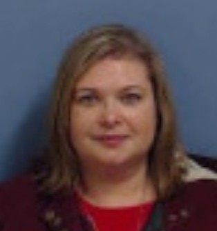 Rachelle Fobbs headshot with red top and blue background