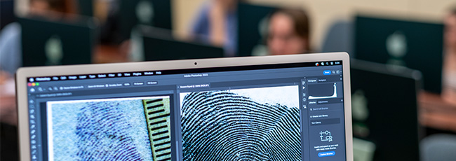 forensics graduate students working in a computer lab