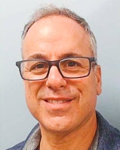 Adam Lippe headshot with glasses