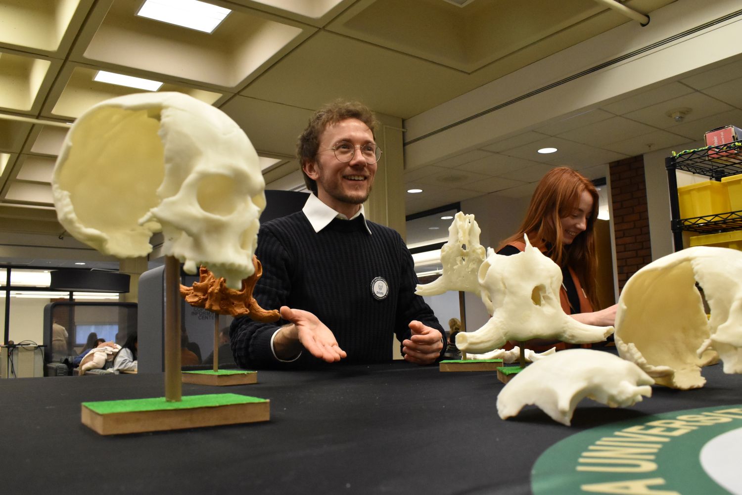 Professor teaching at a table with bones