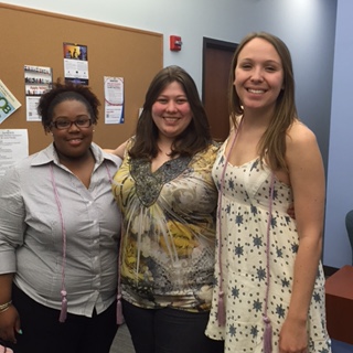 tri-iota inductees wearing their graduation cords