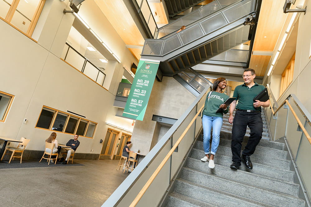 A business student discusses career preparation with a faculty member