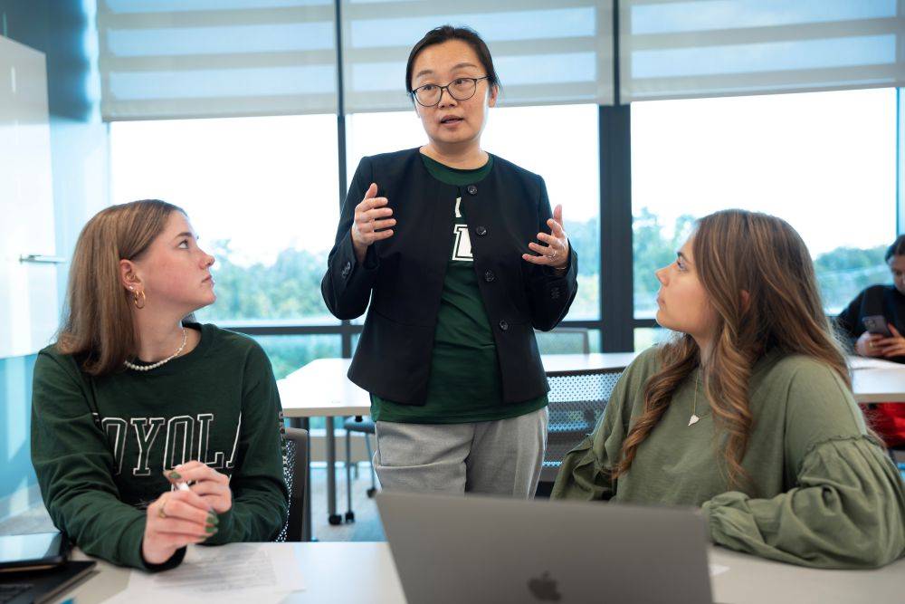 faculty member speaking with two students