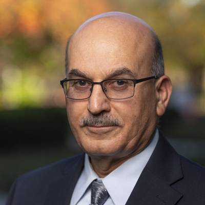 Dr. Bahram Roughani professional headshot in coat and tie