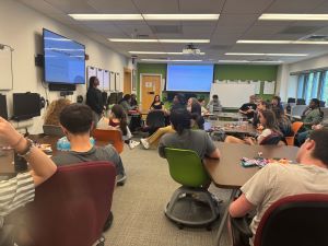 a student presenting in front of a class of students