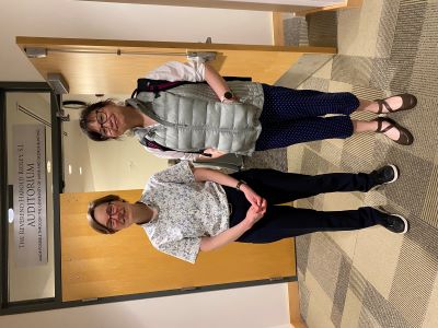 Jennifer Holt and Yu Stearns standing facing the camera and smiling