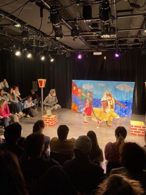 a theater event with people dressed up as a cat and a bird