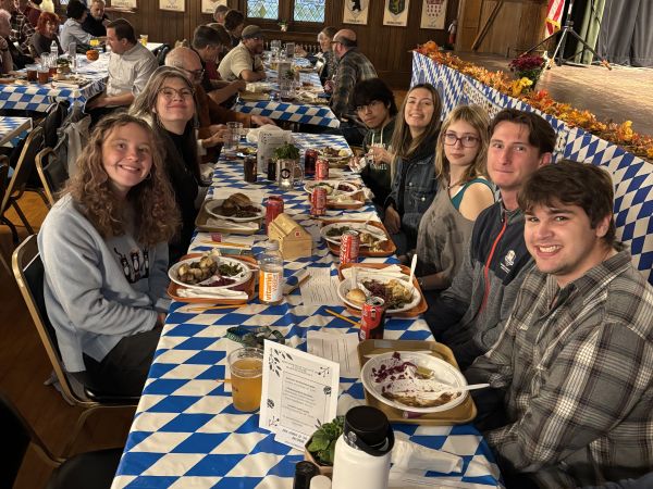 students at a table in a large church room