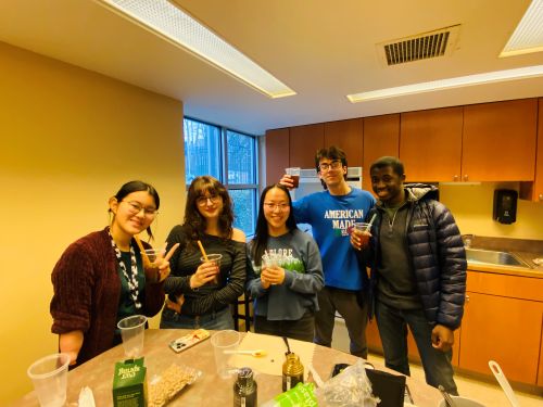 college students posing for picture with cups of bubble tea