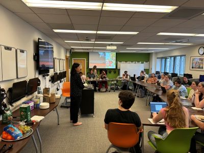 Dr. Jinghua Wangling presenting to a room of college students