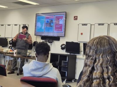 Dr Lopez Rivera presenting a talk in front of college students