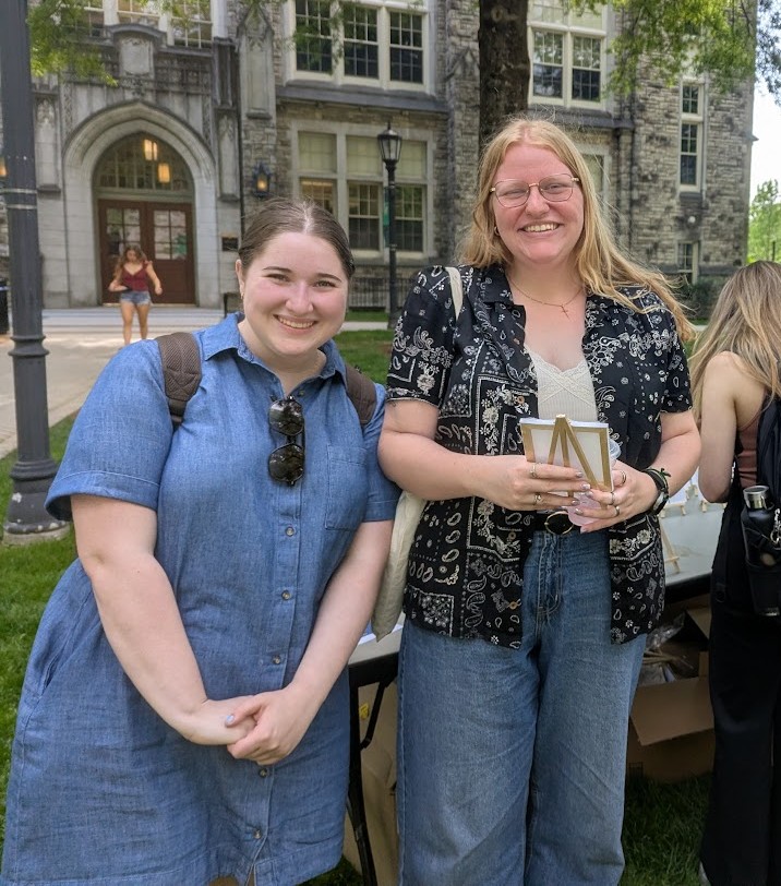 students posing outside at painting event