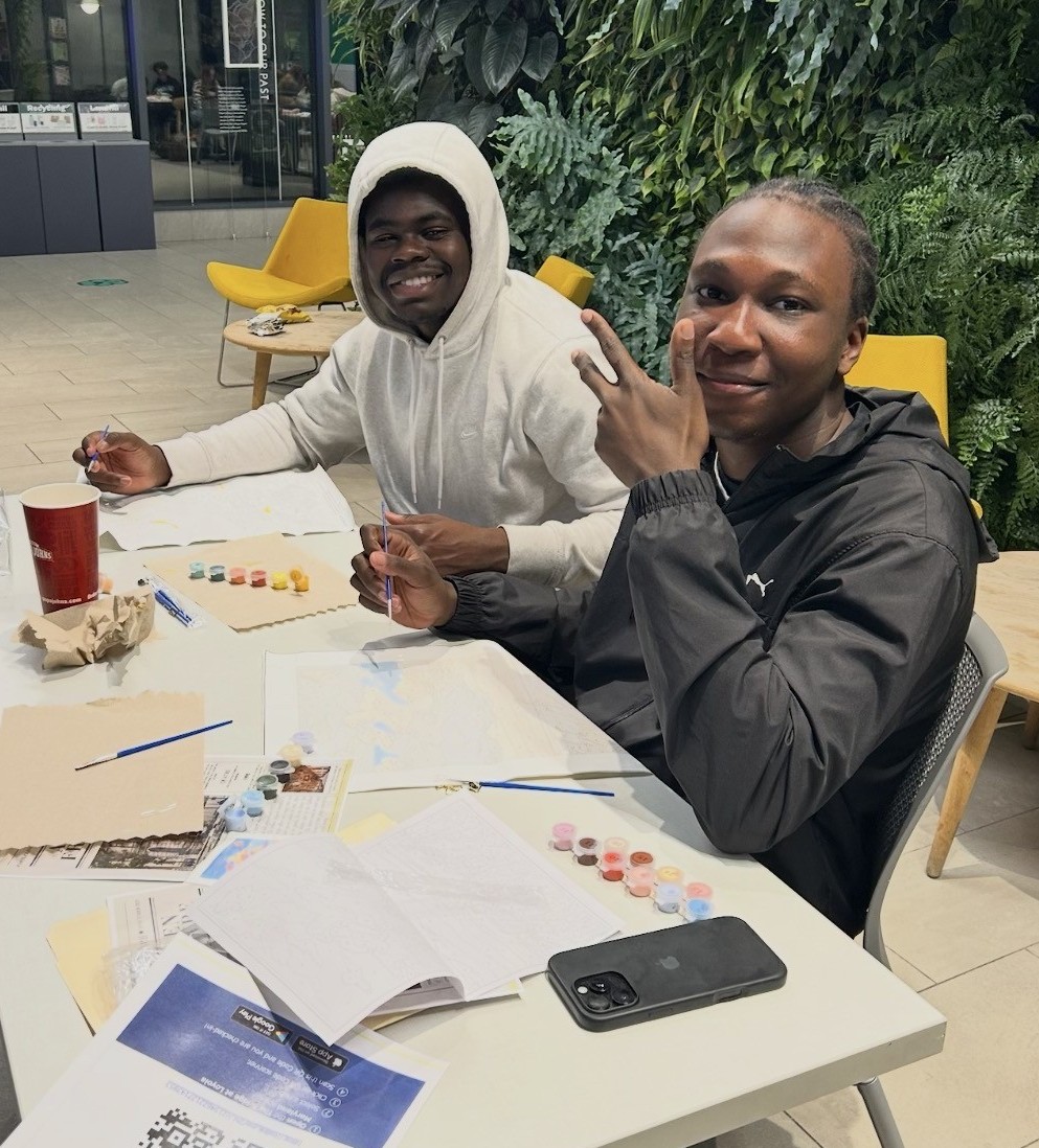 students posing at painting event