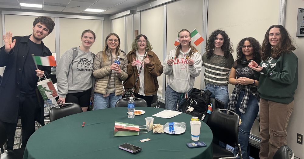 Students posing at Italian Week event with Italian flags