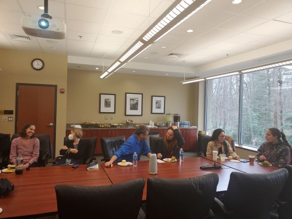 3 faculty and 3 students chatting while eating lunch