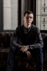 Dr. Michael Loadenthal sitting in front of a window