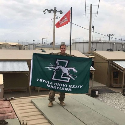 Emily Wolfson (Commissioning Class of ’17) Holds Loyola Flag on Deployment