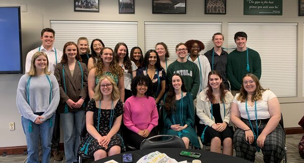 The 2023 Alpha Kappa Delta Inductees sit with their honor cords.