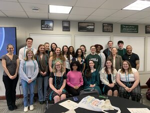 The 2023 inductees of Loyola's chapter of AKD smile, wearing their teal cords, with Drs. Gawerc, Konradi, and Turner.