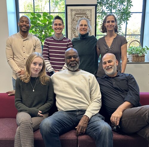 The Sociology department pictured on a couch in the lounge area of Beatty Hall.