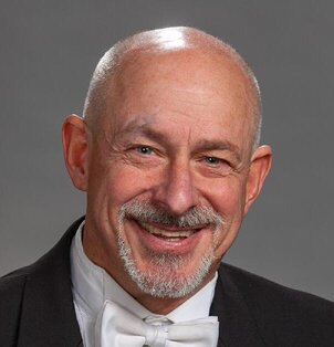 Headshot of Barry Dove holding a cymbal