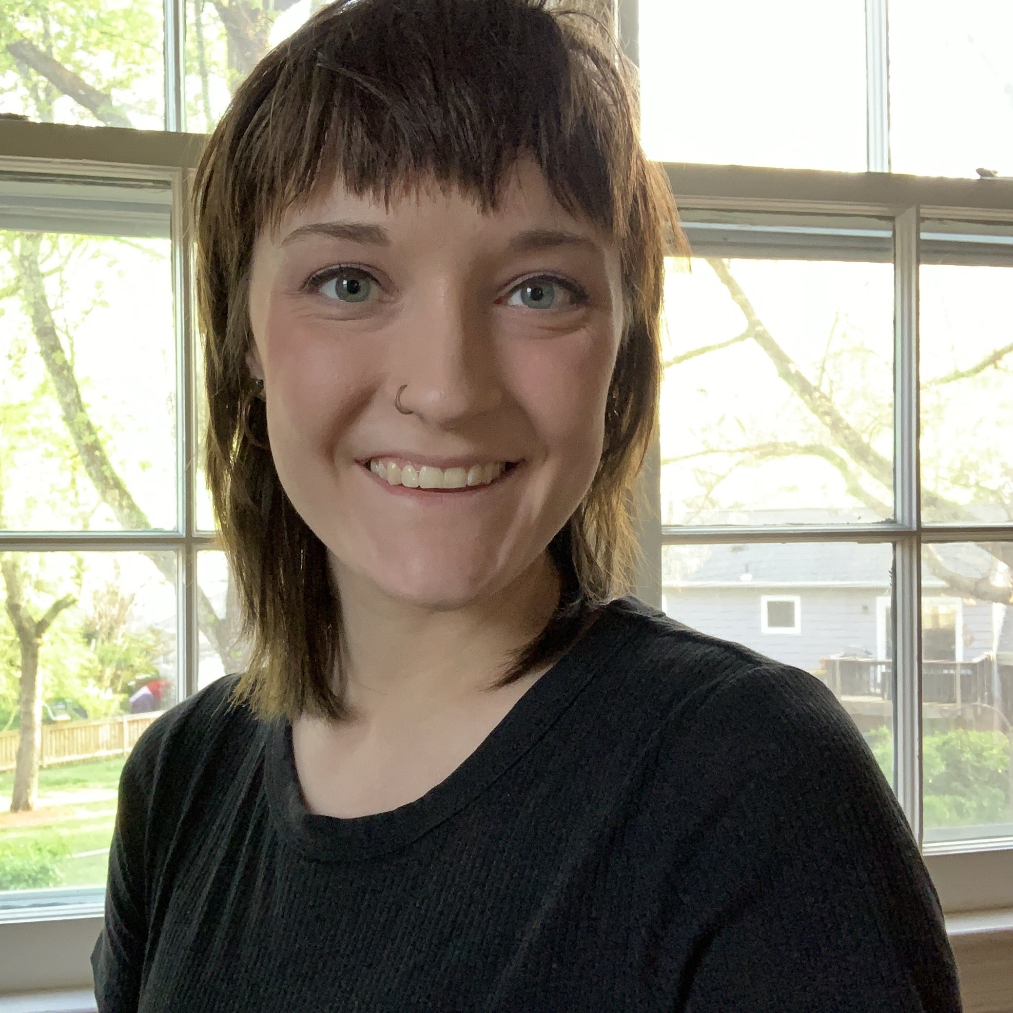 Natalie Jurkowski smiling and wearing a black shirt