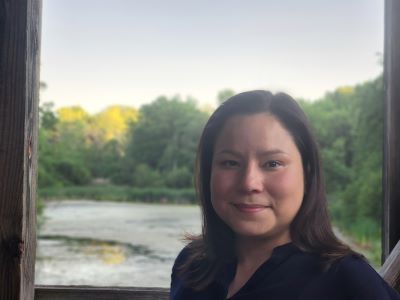Karin Lin-Greenburg in front of green scenic backdrop