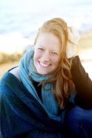 portrait of Emily Dillon on a beach dressed in blue