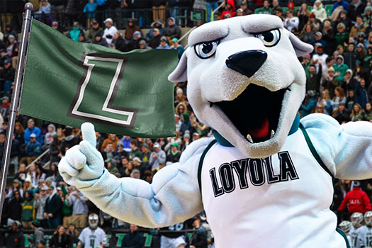 Iggy, the greyhound mascot, throwing up his hands at a packed athletics competition