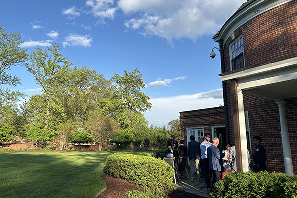 Loyola President Terry Sawyer mingles with students and alumni on the patio outside of Alumni House
