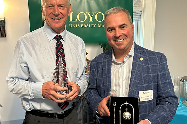 Loyola President Terry Sawyer and Newcastle University Vice Chancellor and President Chris Day pose with gifts they exchanged in celebration of 30 years of global learning partnership