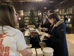 Loyola community enjoying traditional foods during Hanukkah celebration