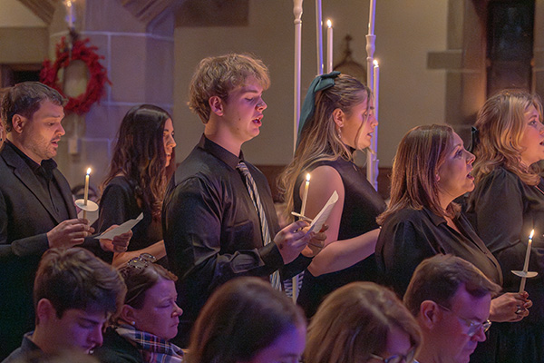 Chapel Choir processing with candles during Lessons and Carols 2024