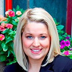 Christine Mahady, Ed.D., in front of a colorful flower bush