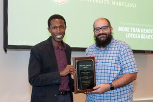 two men holding a plaque