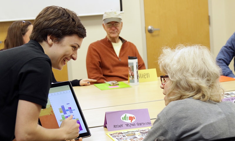 Loyola Clinical Center assistant helping a patient use a tablet computer