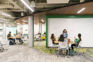 students sitting at different parts of the common area near the CIE in the Student Center