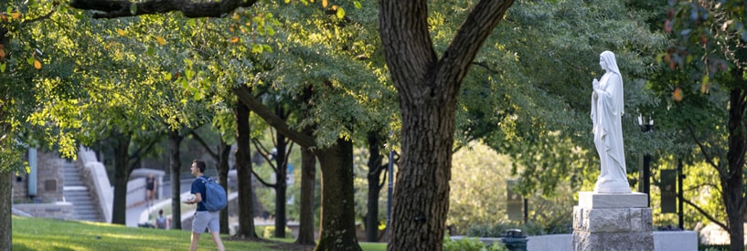 The Mary statue on the quad during a bright morning on campus