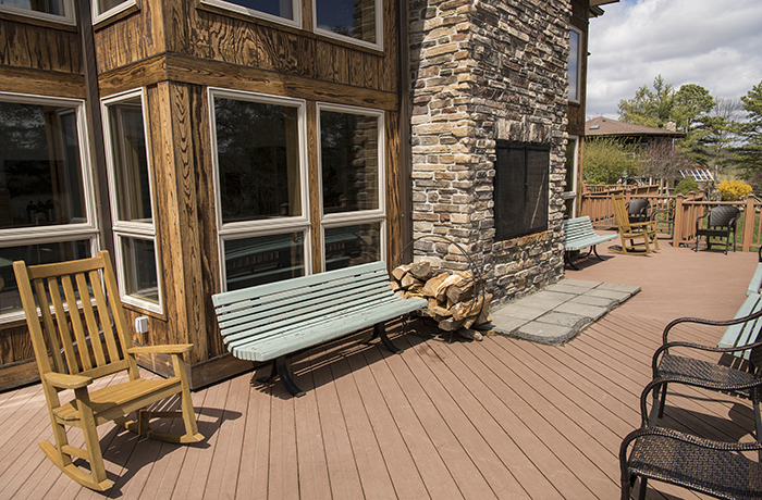 The exterior of Loyola's Retreat Center, featuring a fireplace and ample deck seating