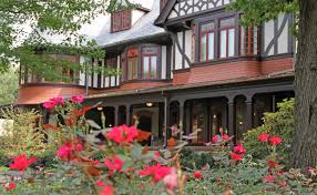 Photo of the Humanities building on Loyola University Maryland evergeen campus. Pink flowers are in the foregroundrs 