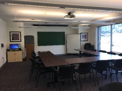 tables arranged in horseshoe shape, chalkboard