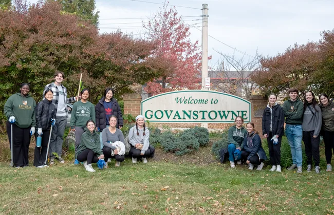 Students pose for a picture after doing clean-up service around the Govanstone sign