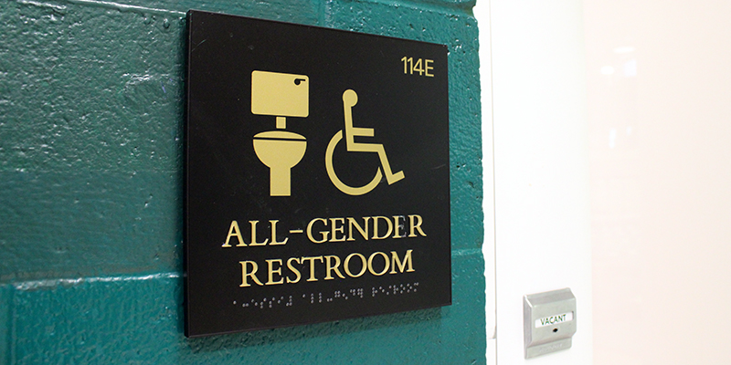 Interior of restroom, showing scale, mirrors, hair dryer, hand dryer, and paper towels